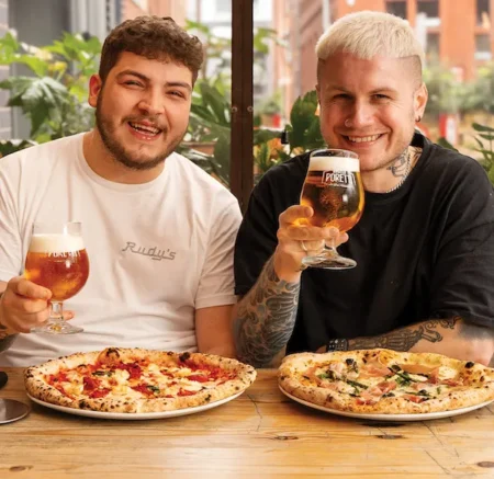 people drinking and enjoying neapolitan pizza