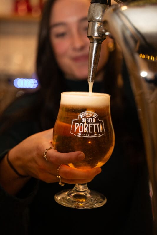 person pouring tap beer