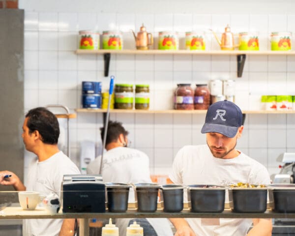 kitchen staff making pizza