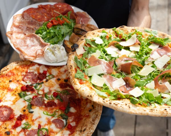 rudy's authentic neapolitan pizza plates with pizza and appetizers