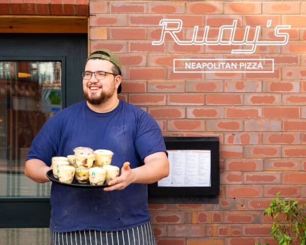 rudys neapolitan pizza restaurant staff holding tray with desserts